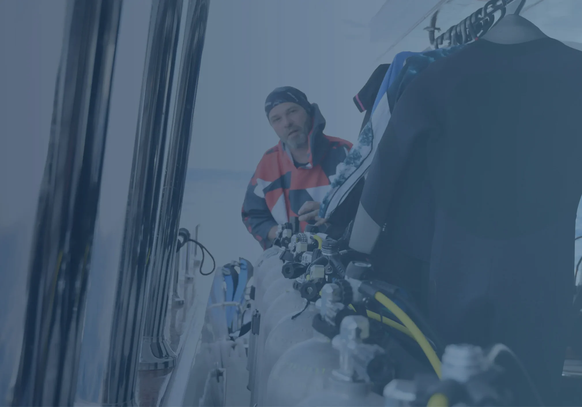 Diver preparing equipment on a boat before a dive.
